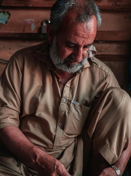 an old man is sitting and enjoying a cup of coffee