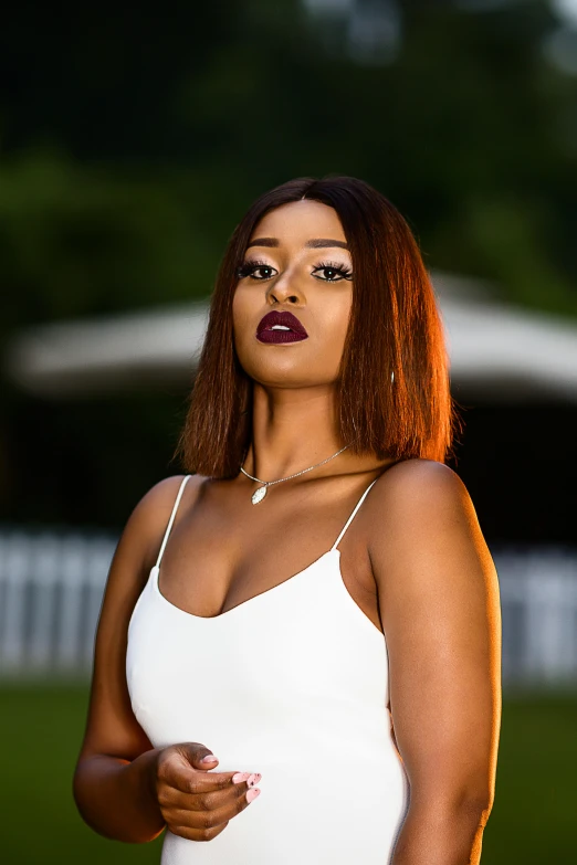 a beautiful woman with red lipstick and long hair posing for the camera