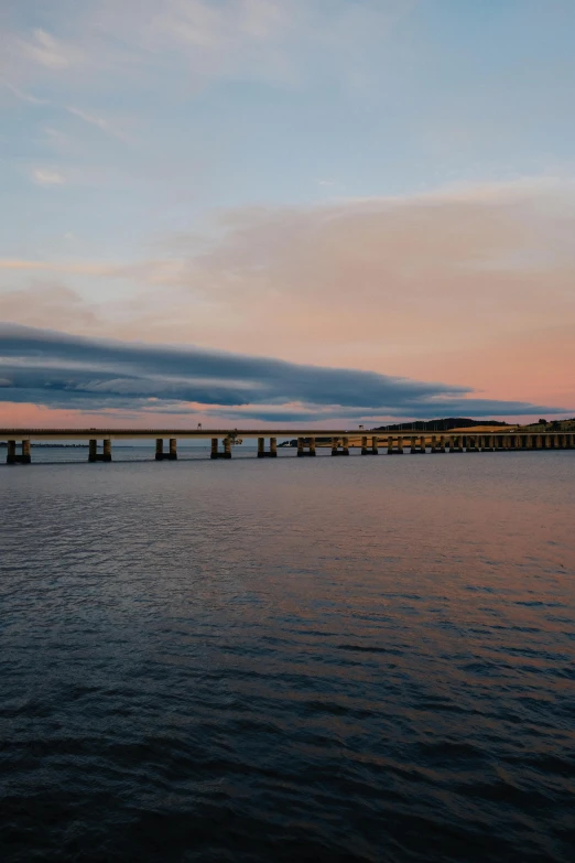 a bridge stretching into a body of water