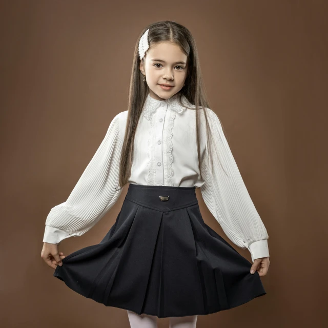 girl posing in schoolgirl's uniform in the studio