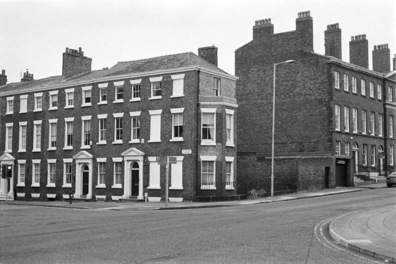 an old black and white pograph of the back of a house