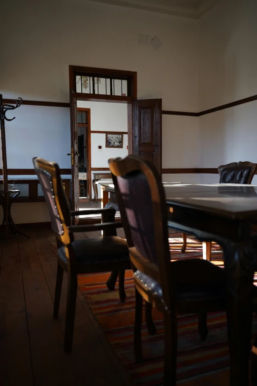 a long wooden table with a chair near by