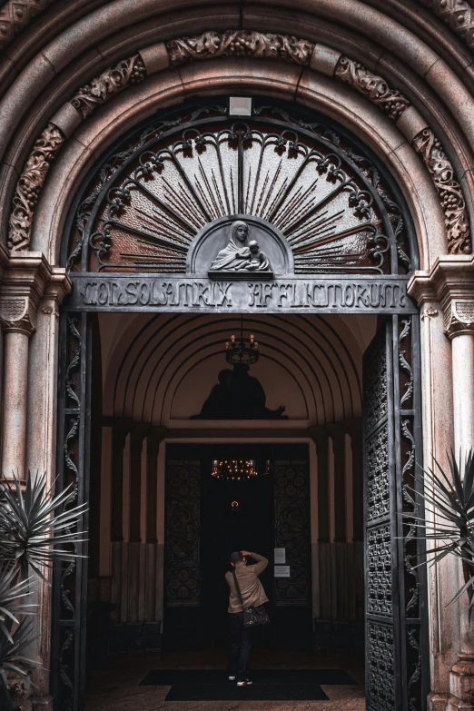 an image of a person taking a picture of the entrance of a building