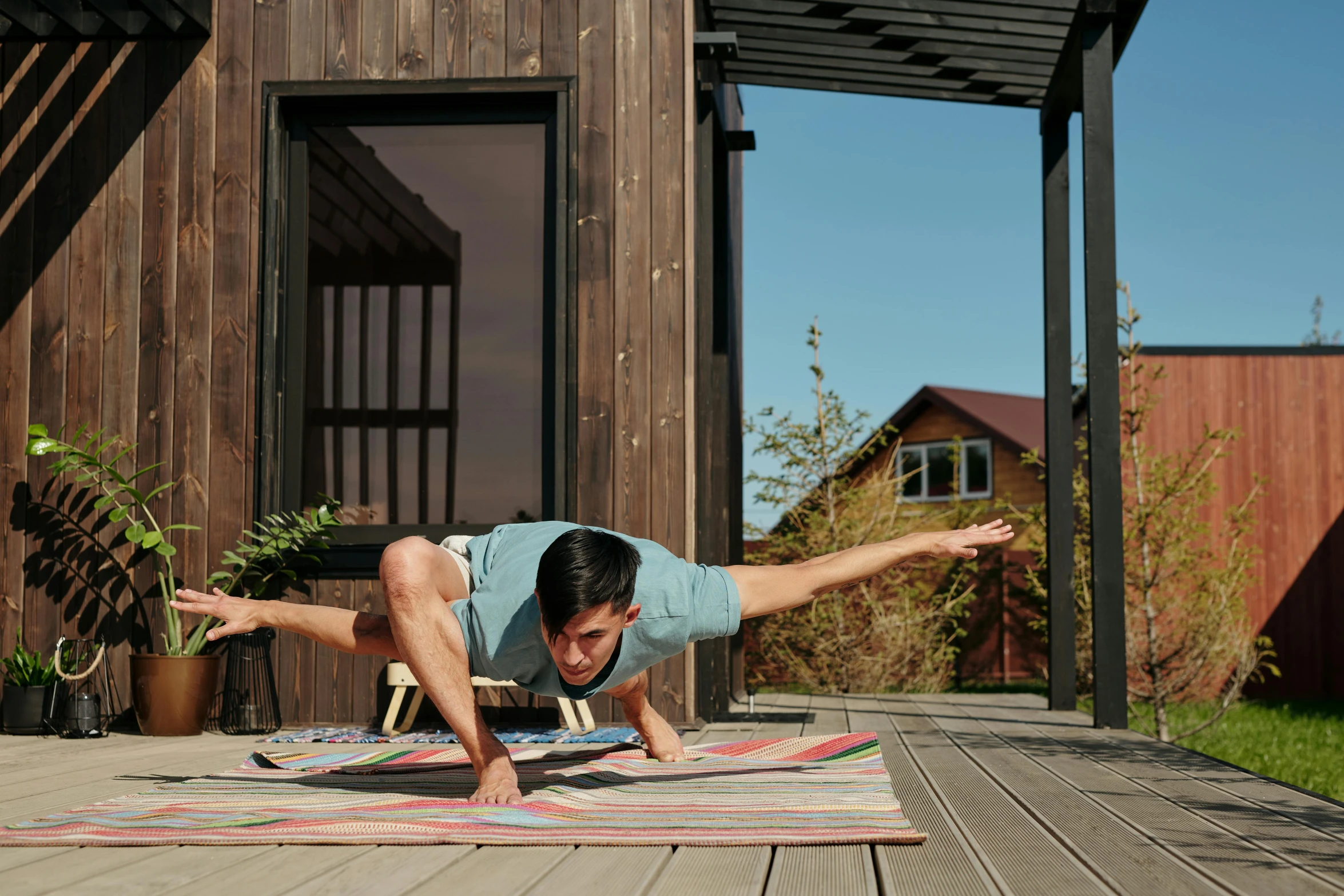 a woman is doing a back handstand on the rug