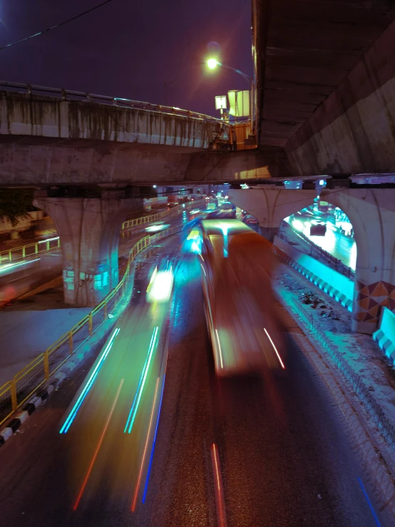 a traffic traveling under a bridge at night