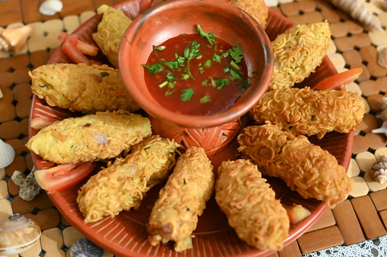 several fried food items are placed on an orange plate