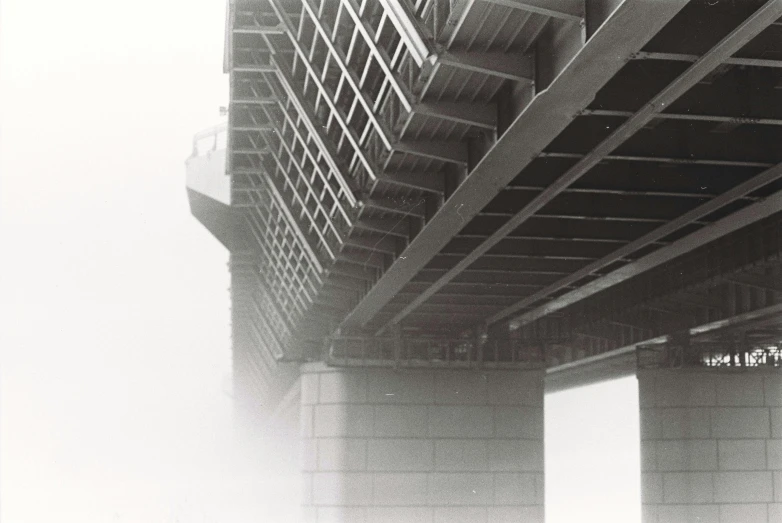 fog covers the street overpass of a bridge