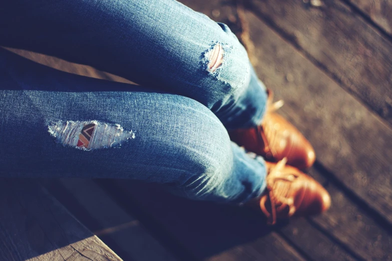 a woman wearing jeans with holes in them
