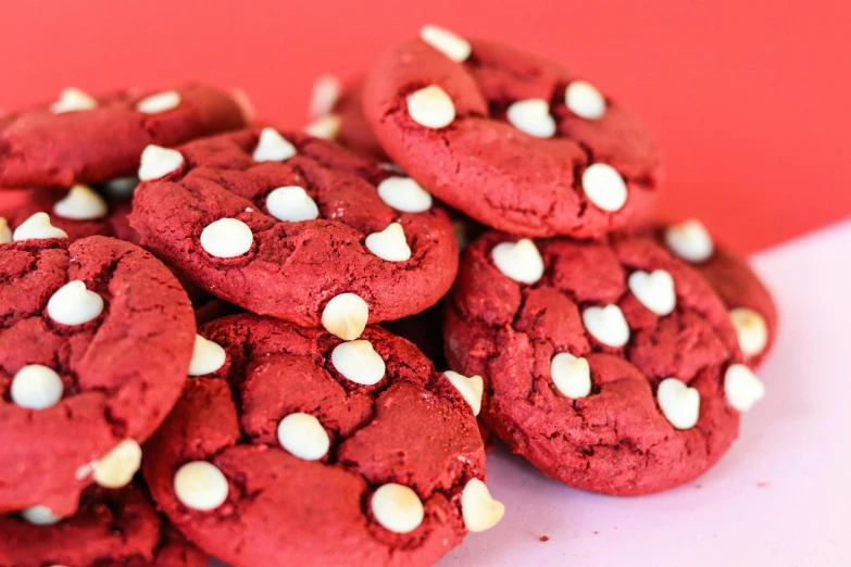 some red cookies topped with white sprinkles