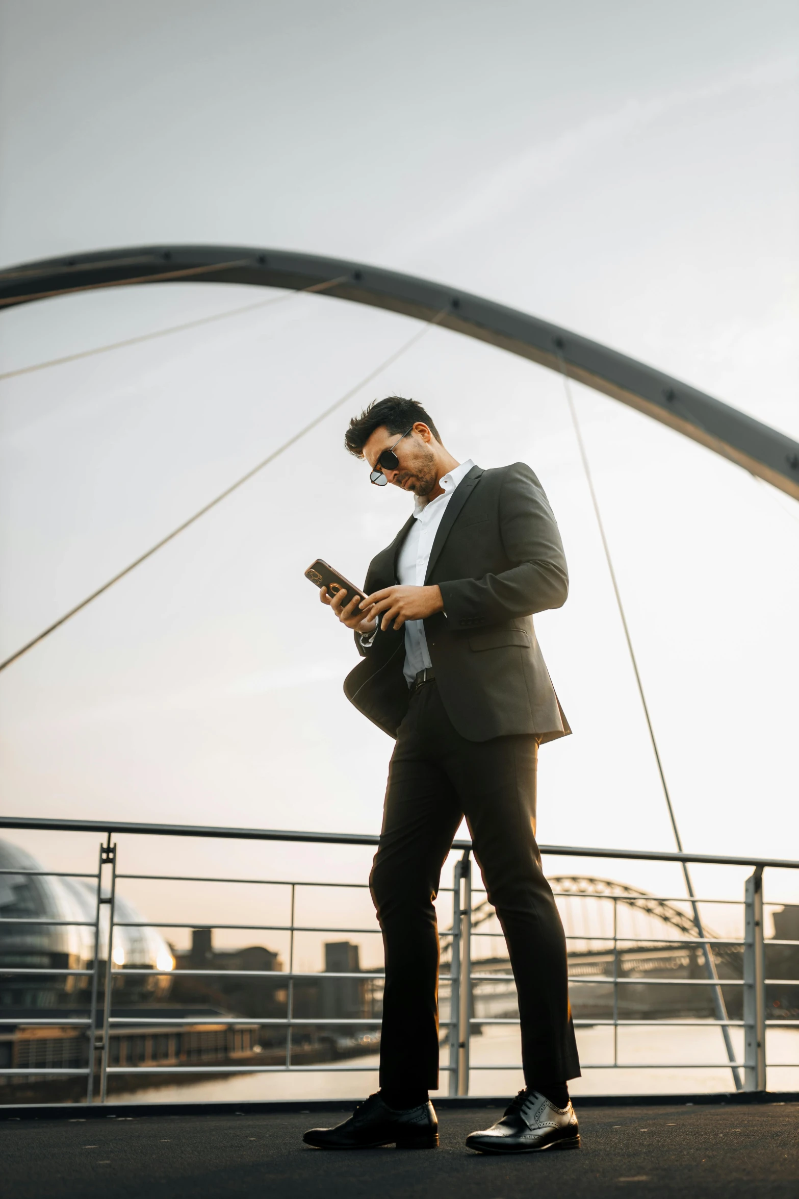 the man walks in the park using his cell phone