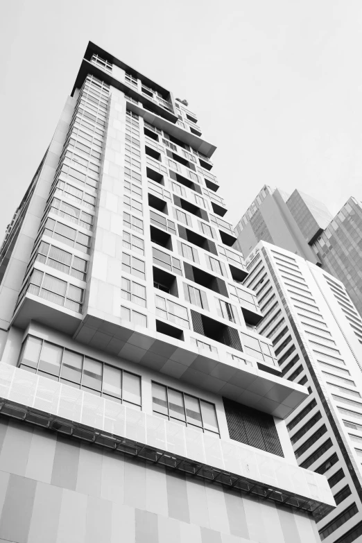 two high rise buildings against a cloudy sky