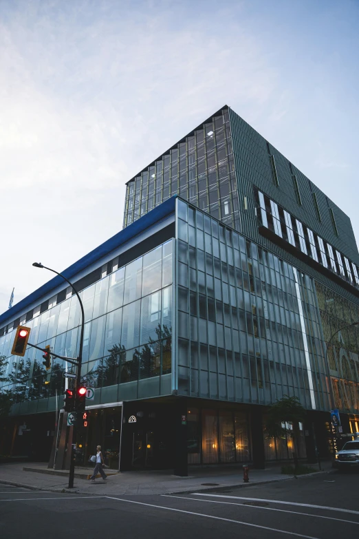 a glass building next to a traffic light