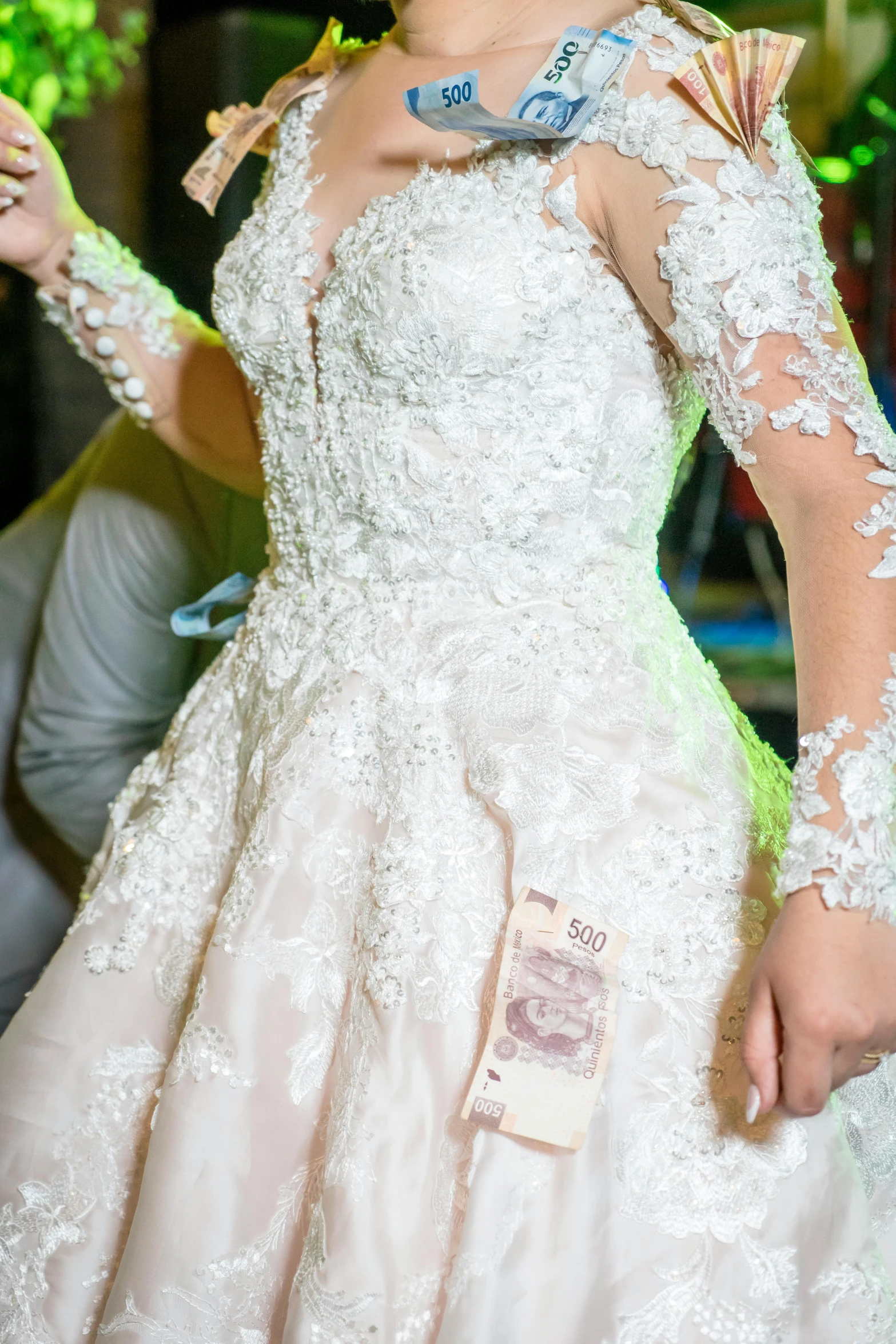 a woman in an elaborate white dress holding a medal