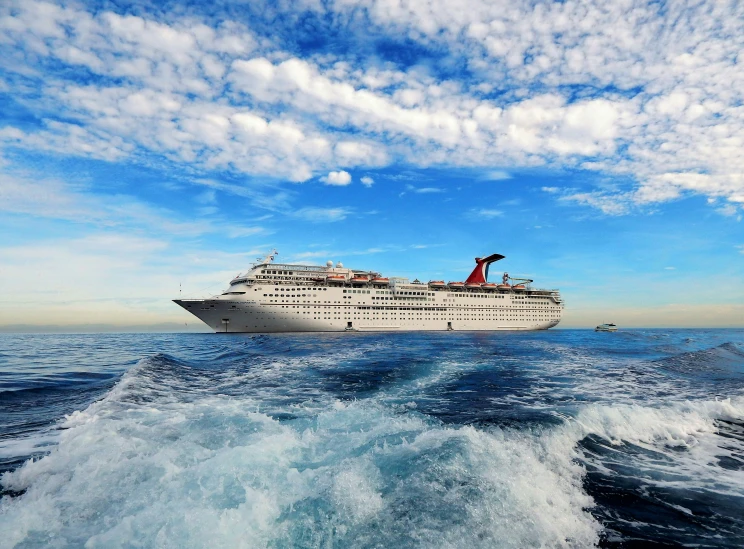 a cruise ship sailing in the ocean during a sunny day