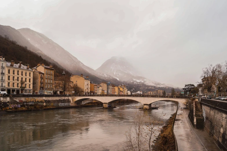 a bridge over the river surrounded by some buildings