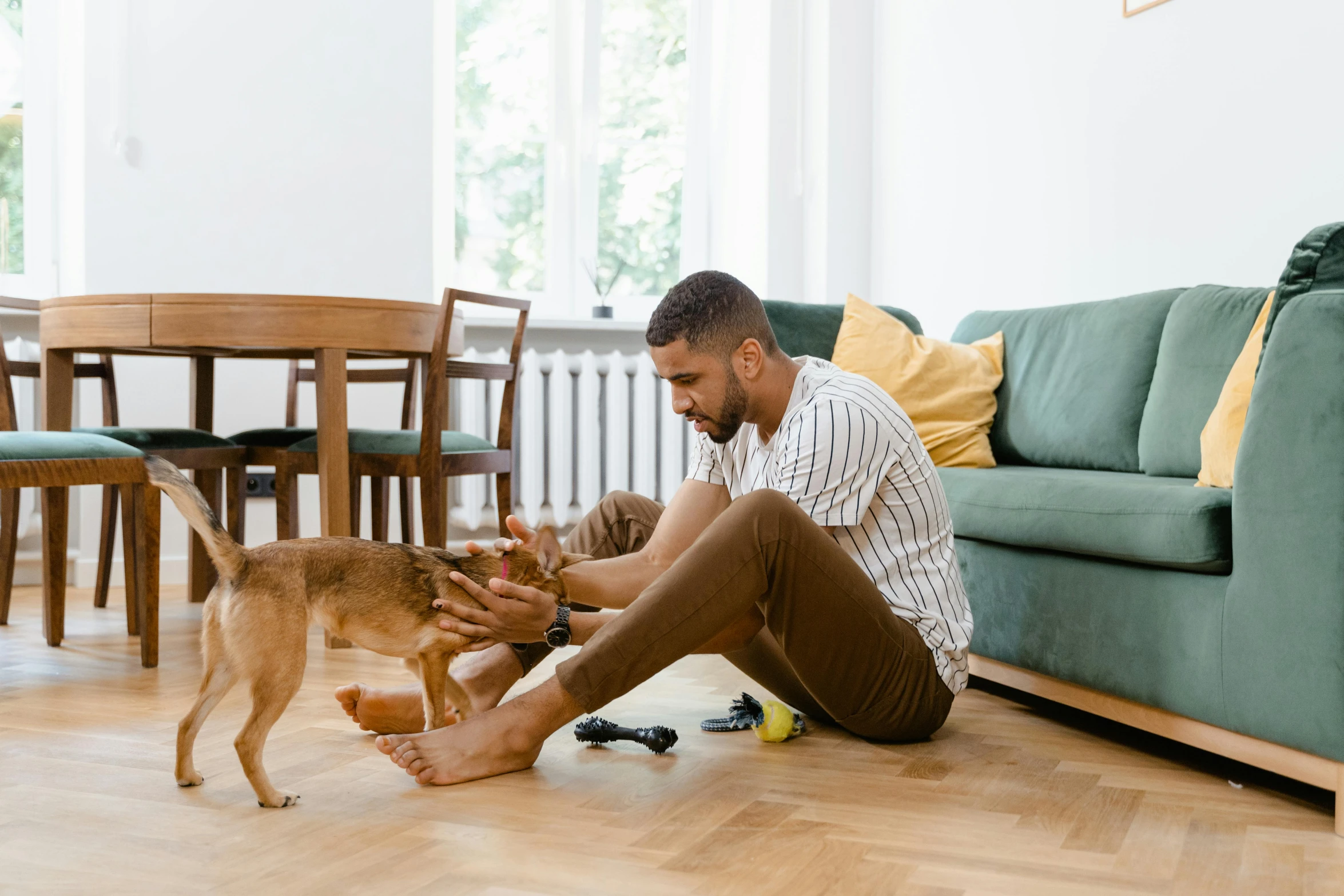 there is a man and his dog sitting on the floor