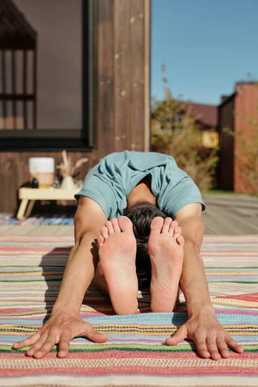 a man is doing yoga exercises on his feet