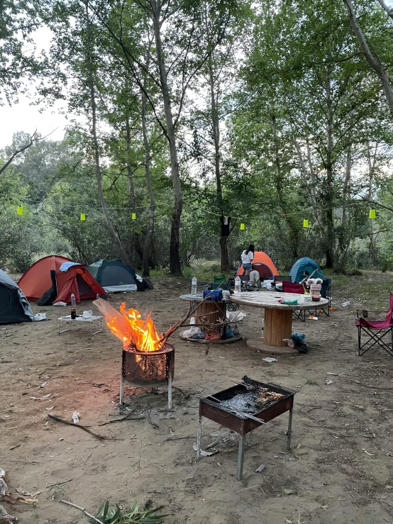 several camping tents and chairs are set up on the sand