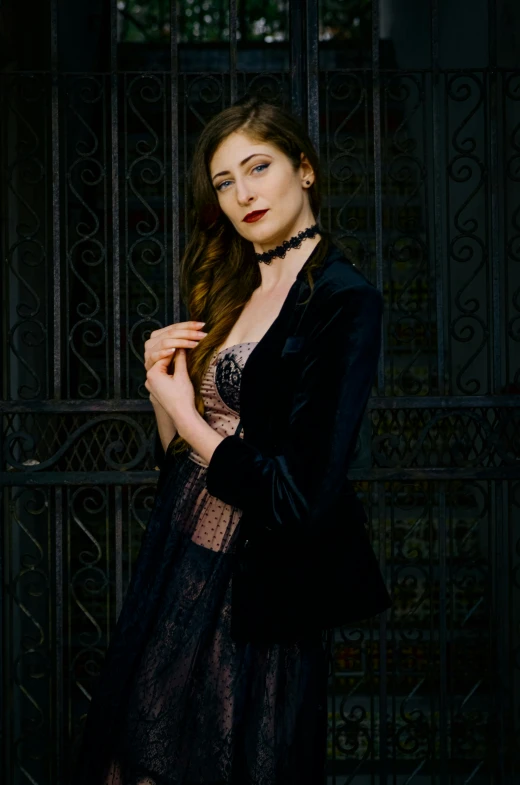 a beautiful young lady leaning against a fence