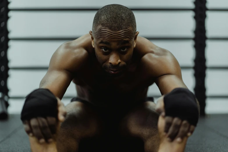 a man posing for the camera with his hands on his knees