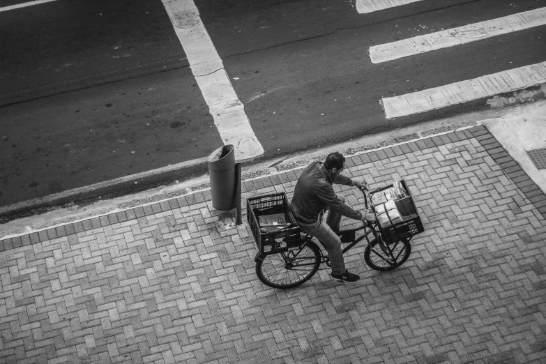 man on a bicycle holding a box near the street