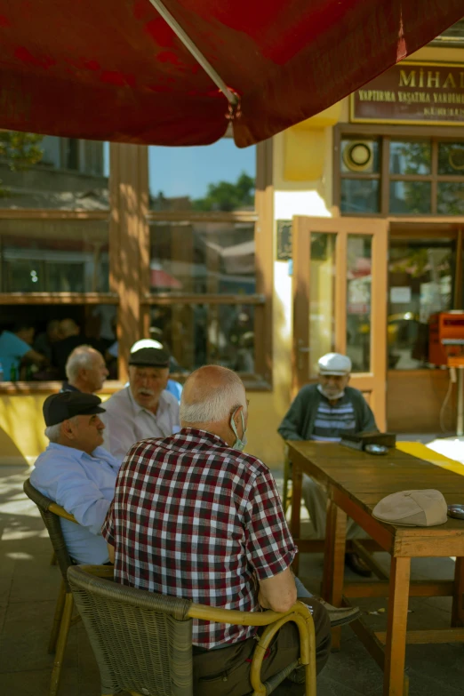 people sitting outside eating outside and walking nearby