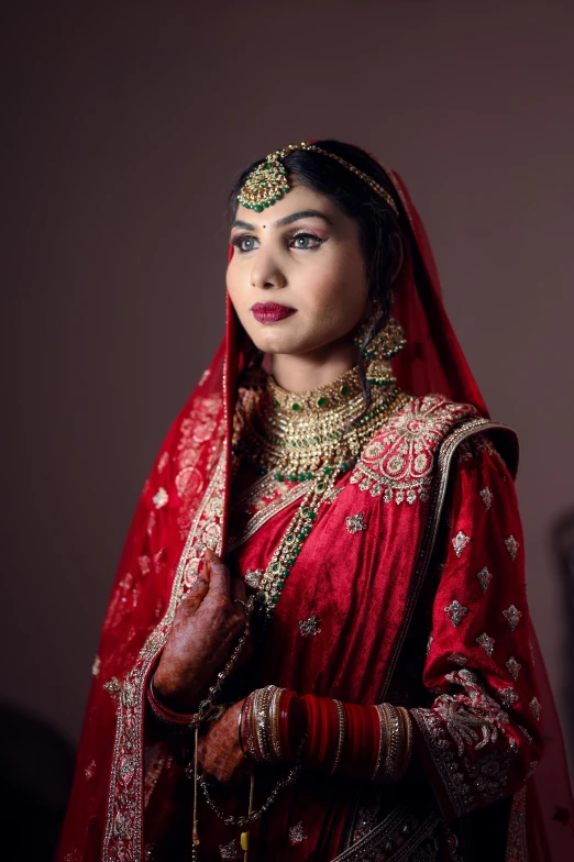 a woman in an oriental outfit and red shawl