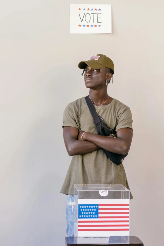 a young man is sitting behind a box that has an american flag on it