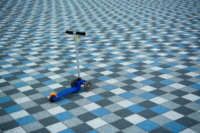 blue motorcycle scooter and pole on checkered tile