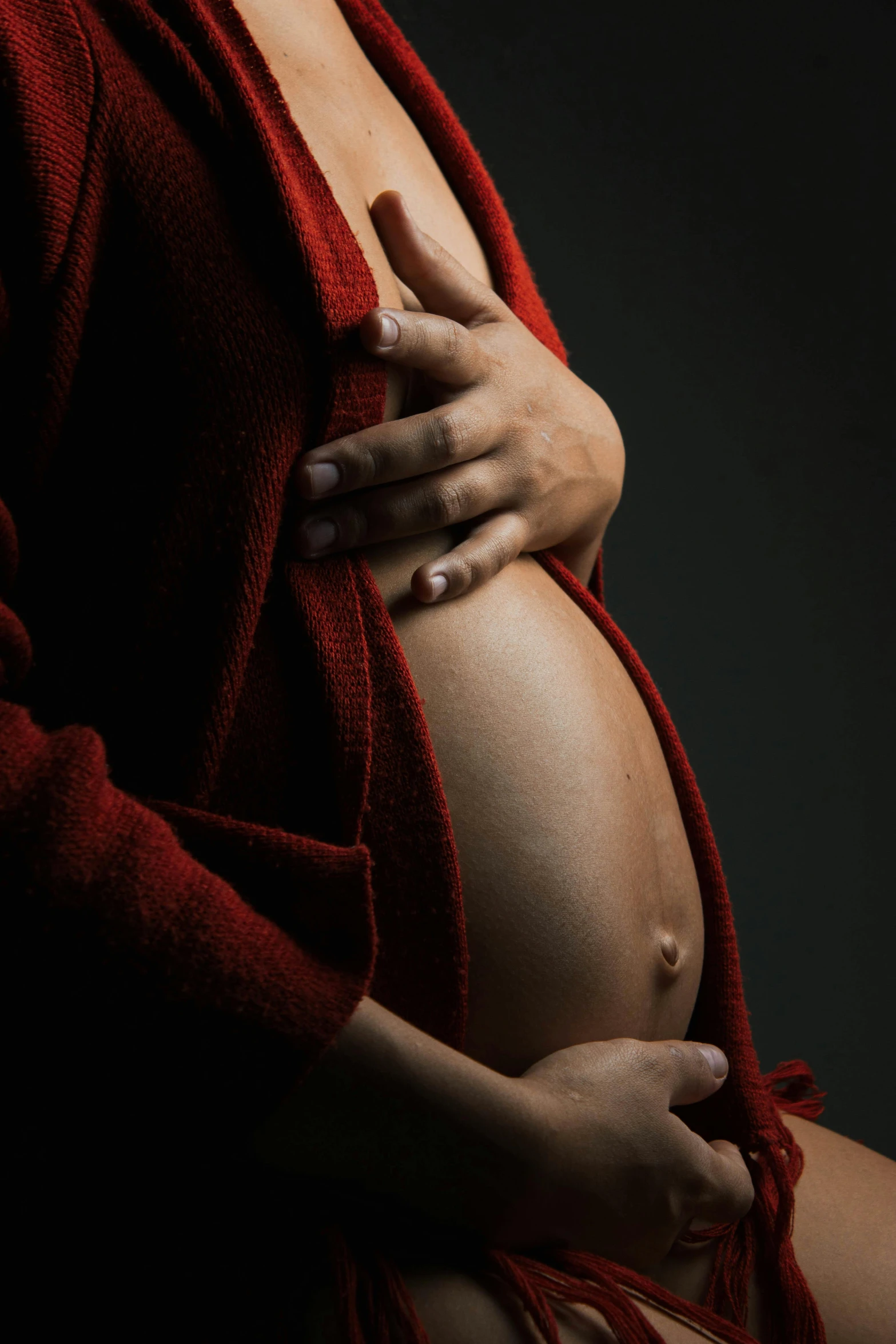 a woman wearing red is holding her stomach