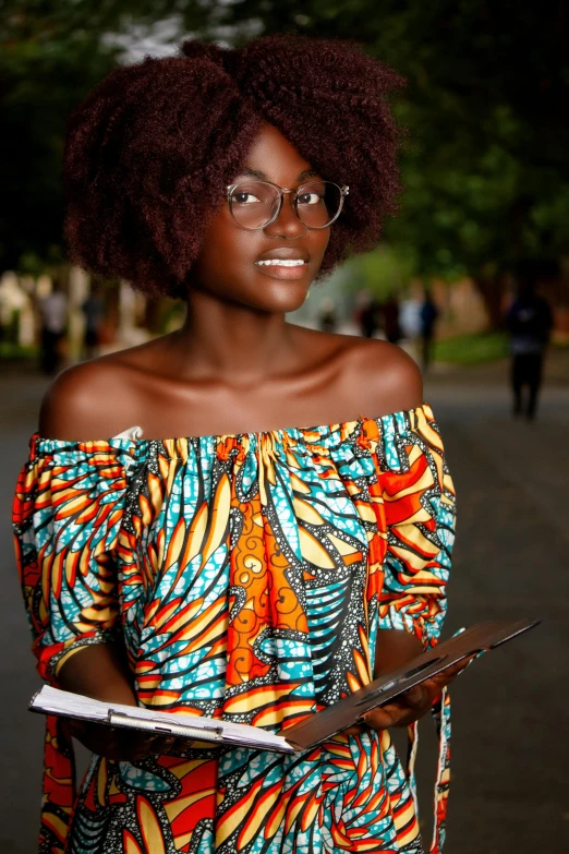 woman in eyeglasses holding a folder on the street