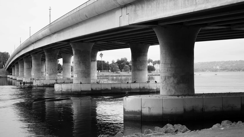 black and white pograph of the underside of a large bridge