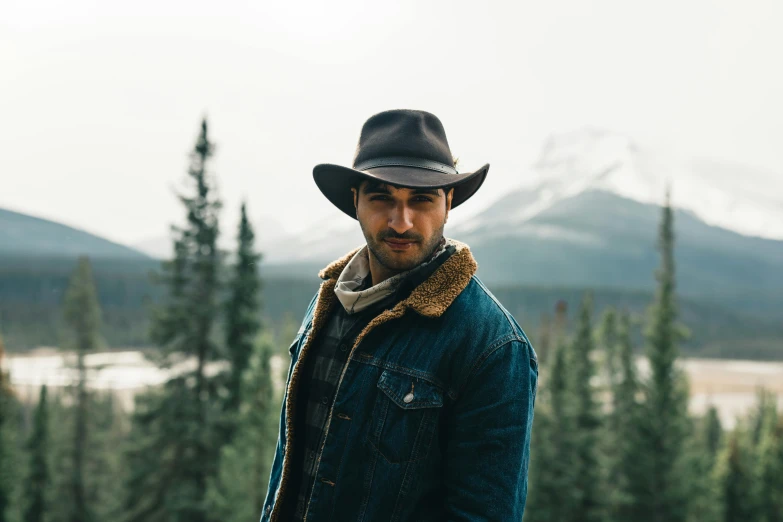 a man with a cowboy hat and coat