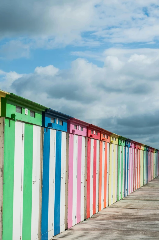 many colorful wooden boards lined up along the beach