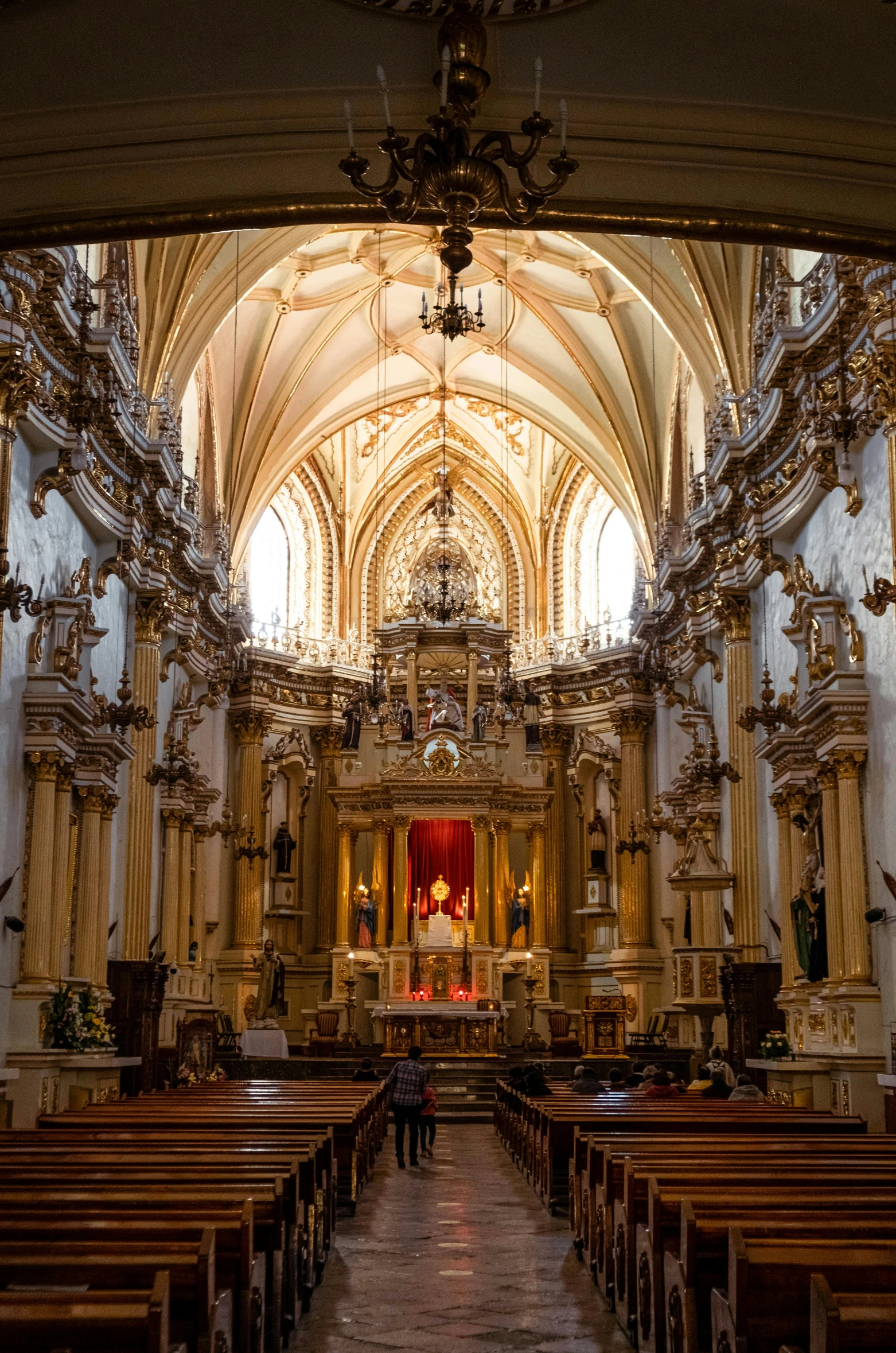 the inside of a cathedral with pews