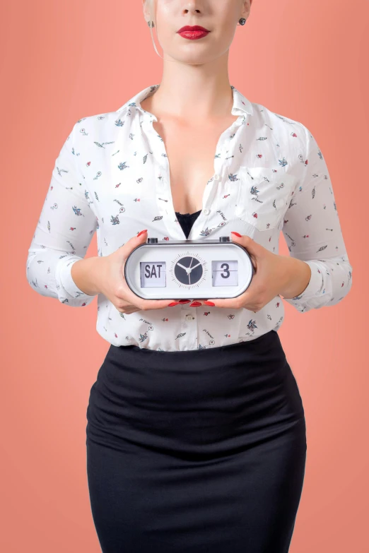 a woman holding a radio while standing on a red background