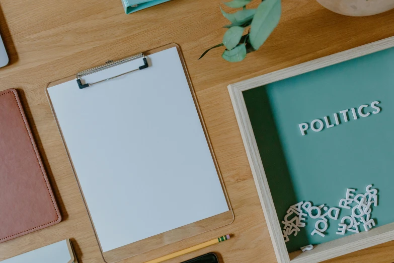 some paper and a clipboard on a table