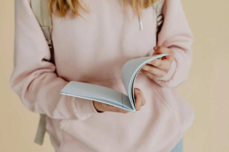 a woman with blonde hair holding a folder