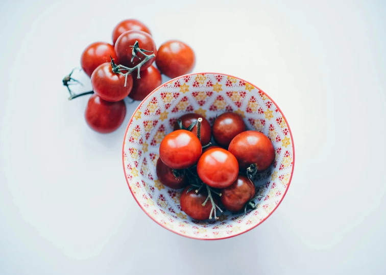 tomatoes are in a bowl with other foods in it