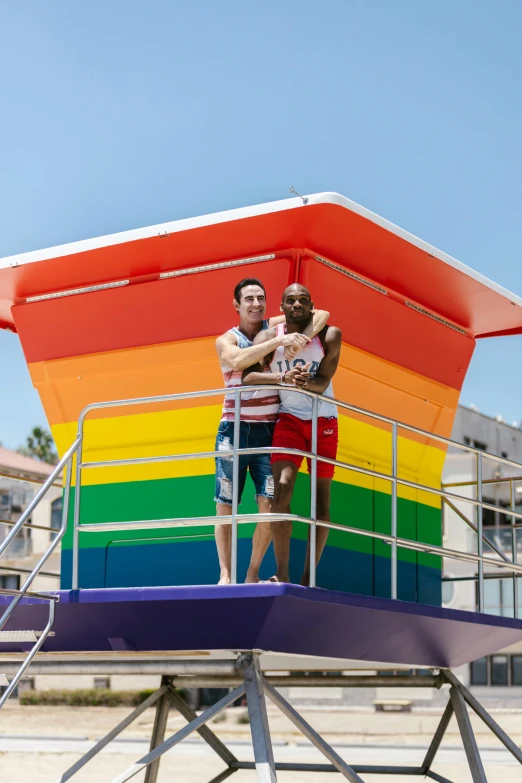 a man and a woman on a tower in front of a building