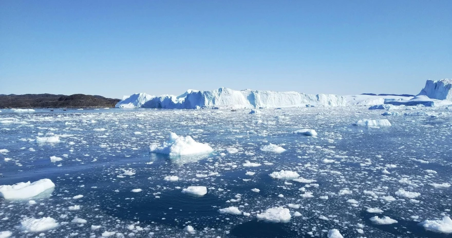 some icebergs in the ocean on a sunny day