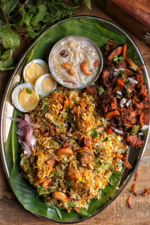 a plate full of food with rice, meat and sauce