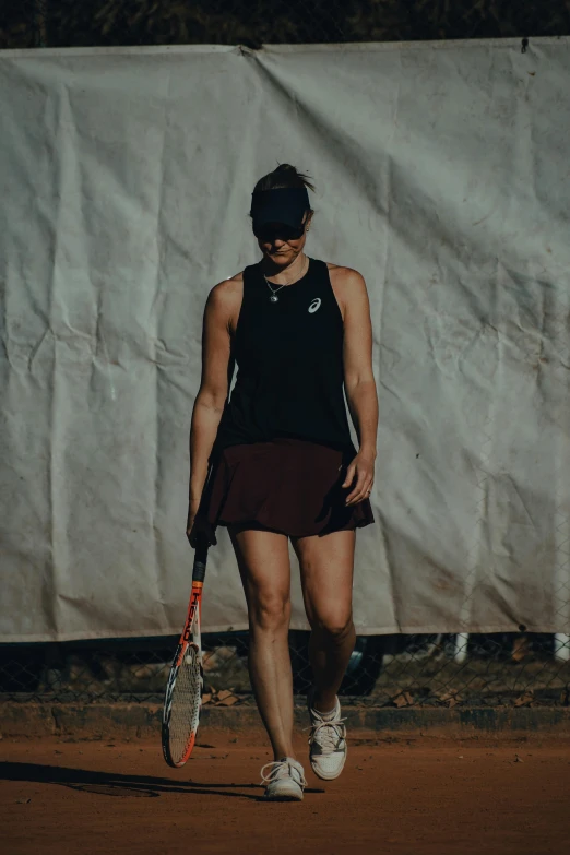 a girl holding a tennis racquet in her hand