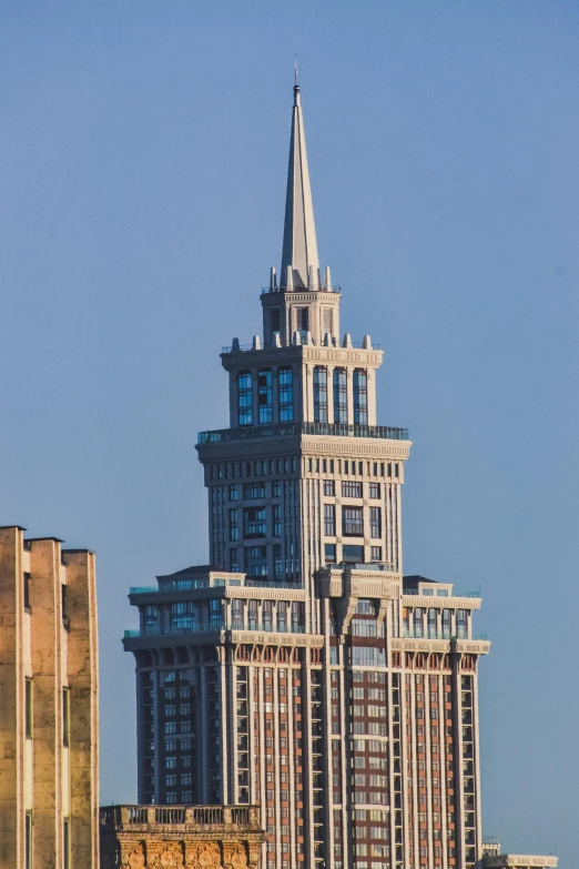 a tall building with a steeple on top in the city