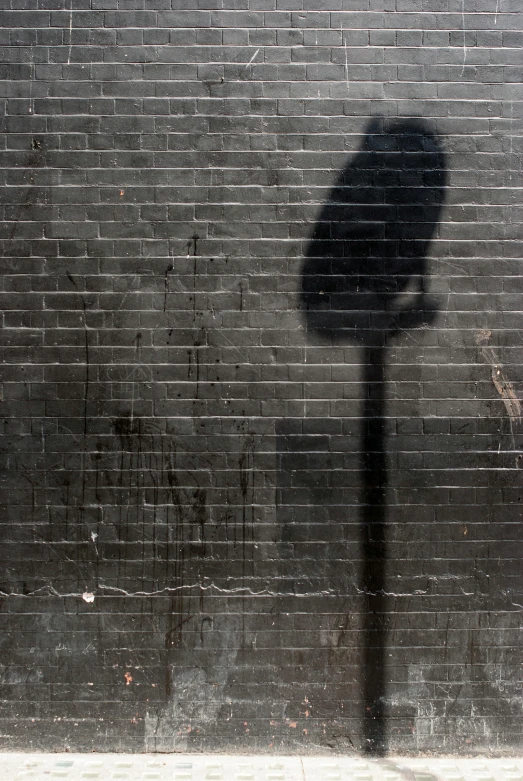 a shadow of a pole on the wall