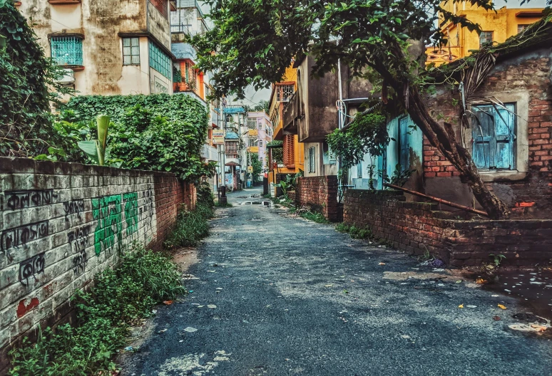 a street has green and yellow houses on both sides