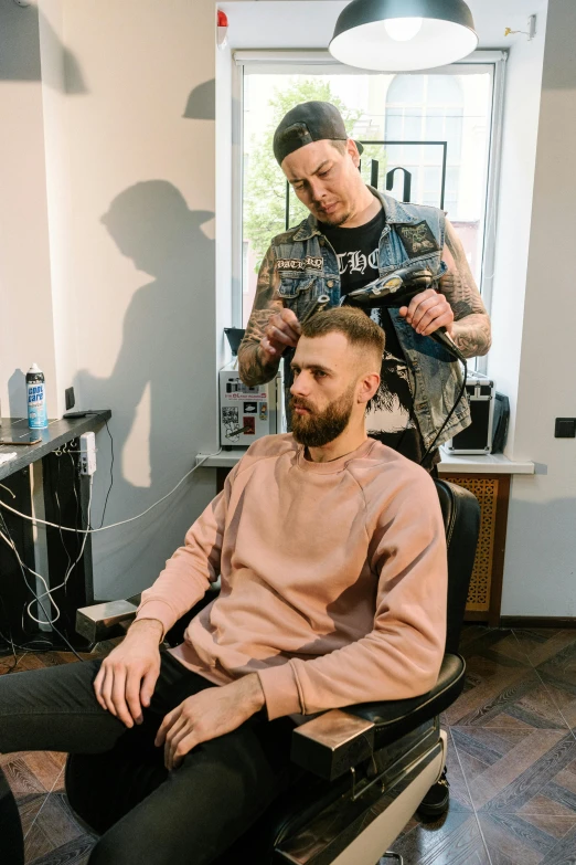 a man getting his hair cut at the hair dresser