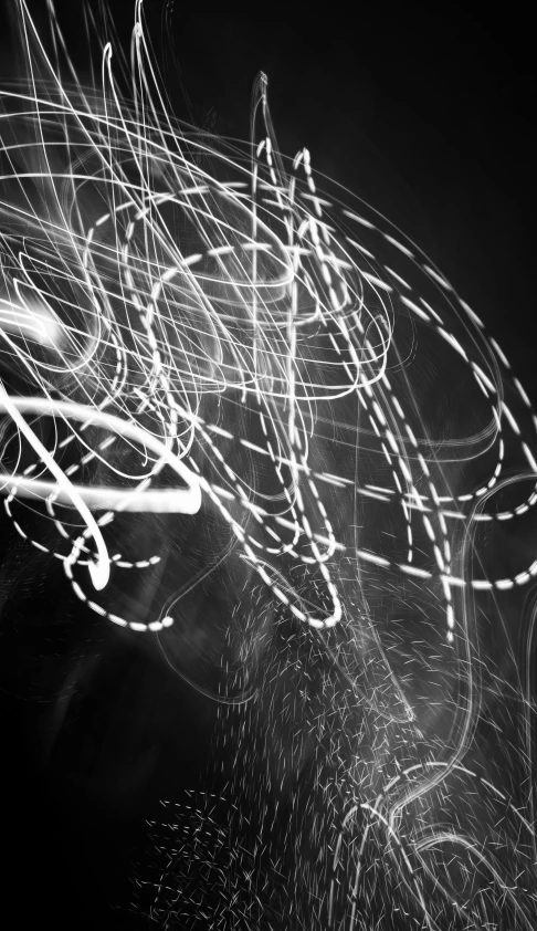 light painting on black and white po of person on bike