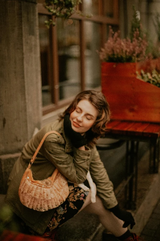 a woman sitting on a bench with her handbag