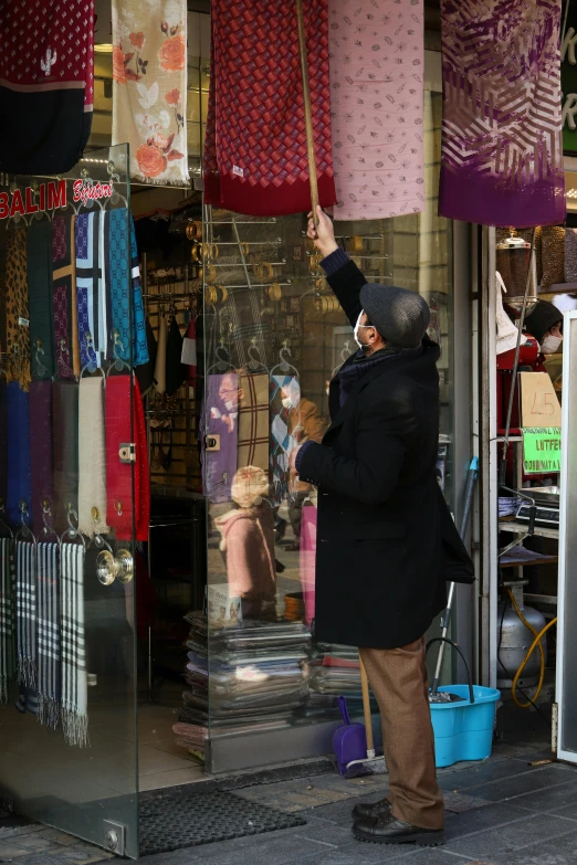 a man is reaching for an item that he is holding in his hand